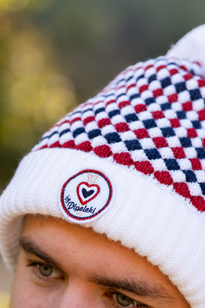 Bonnet pompom blanc à carreaux